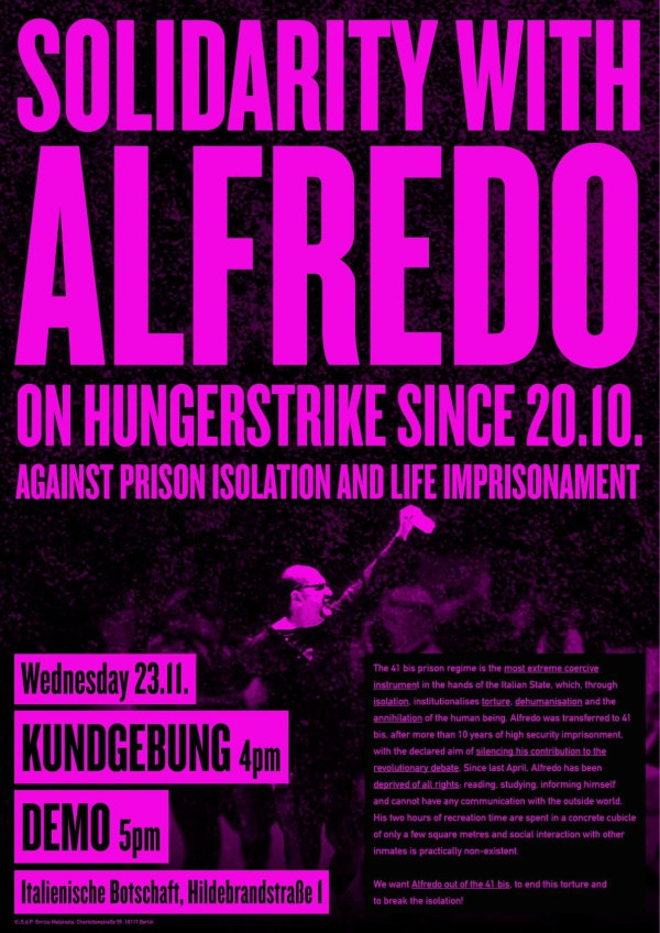 The poster has a black background with bright pink text reading "Solidarity with Alfredo on hunger strike since 20.10. Against prison isolation and life imprisonment." A man holds a microphone. Event details: "Wednesday 23.11. Kundgebung 4pm Demo 5pm Italienische Botschaft, Hildebrandstraße 1." A paragraph describes prison conditions.